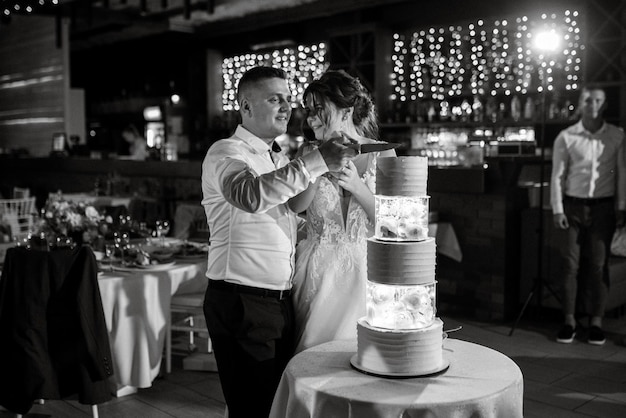 Newlyweds happily cut laugh and taste the wedding cake