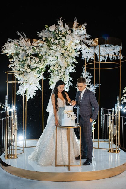 Newlyweds happily cut laugh and taste the wedding cake