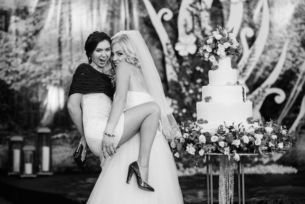 Newlyweds happily cut, laugh and taste the wedding cake