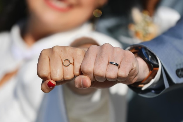 The newlyweds show wedding rings to the camera