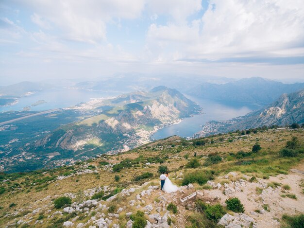 Newlyweds standing on mount lovcen and admire the views