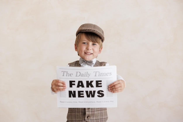 Newsboy shouting against grunge wall background Boy selling fake news