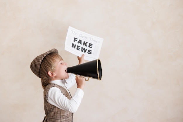 Newsboy shouting against grunge wall background Boy selling fake news