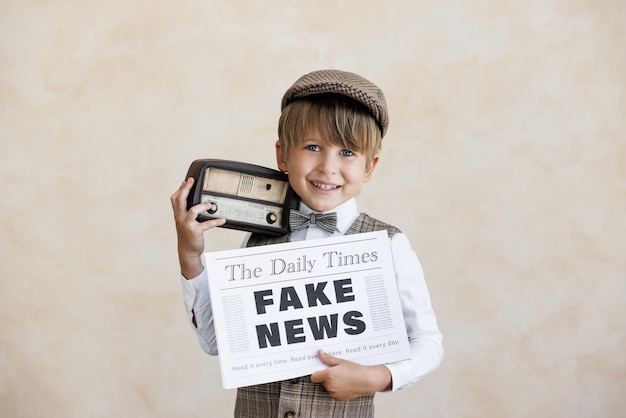 Newsboy shouting against grunge wall background Boy selling fake news