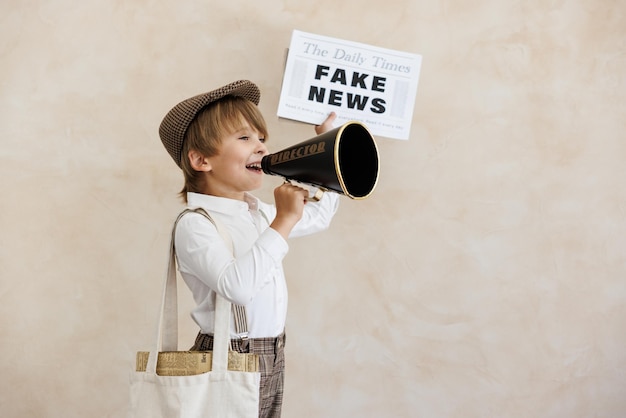 Newsboy shouting against grunge wall background Boy selling fake news