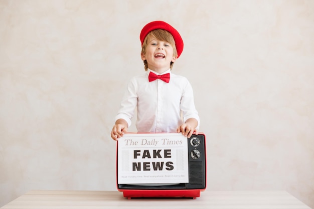 Newsboy shouting against grunge wall background Boy selling fake news