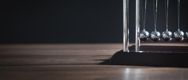 Newton's cradle balls on the wooden table Business