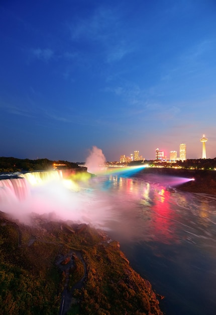 Niagara Falls lit at night by colorful lights