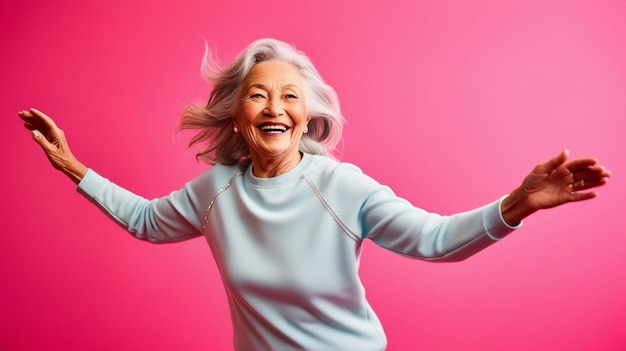 Photo nice aged lady dancing have fun wear blue sweater isolated on pink color background