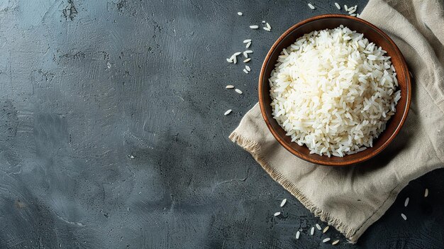 Photo a nice bowl of cooked white rice with copy space on a grey table generative ai