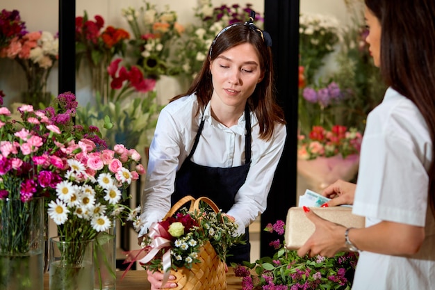 Nice confident entrepreneur woman orangery owner give flowers to client