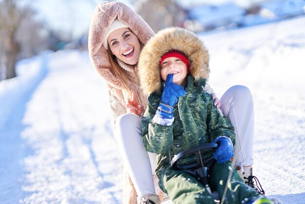 Nice happy family having fun on winter snow. High quality photo