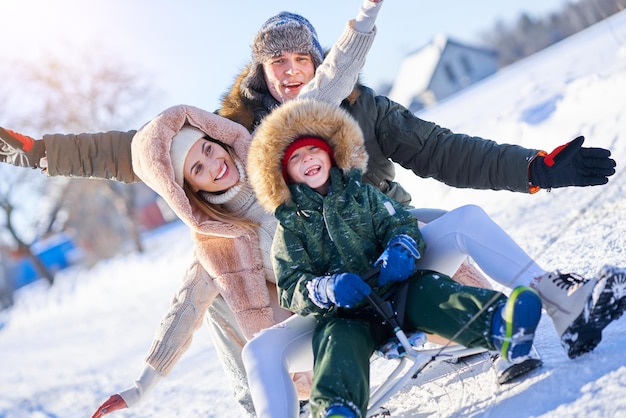 Nice happy family having fun on winter snow. High quality photo