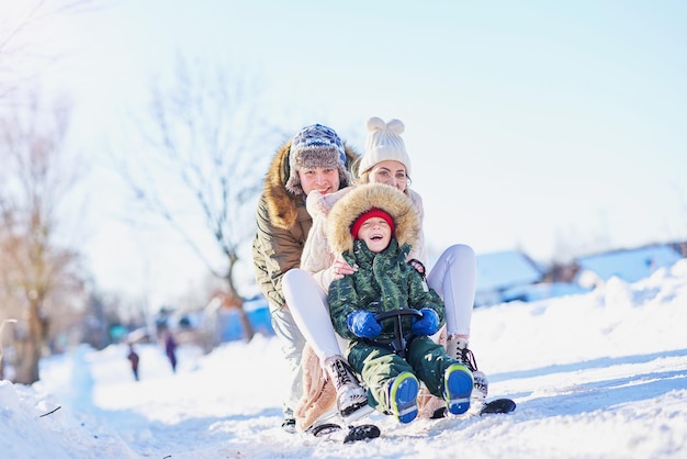 Nice happy family having fun on winter snow. High quality photo