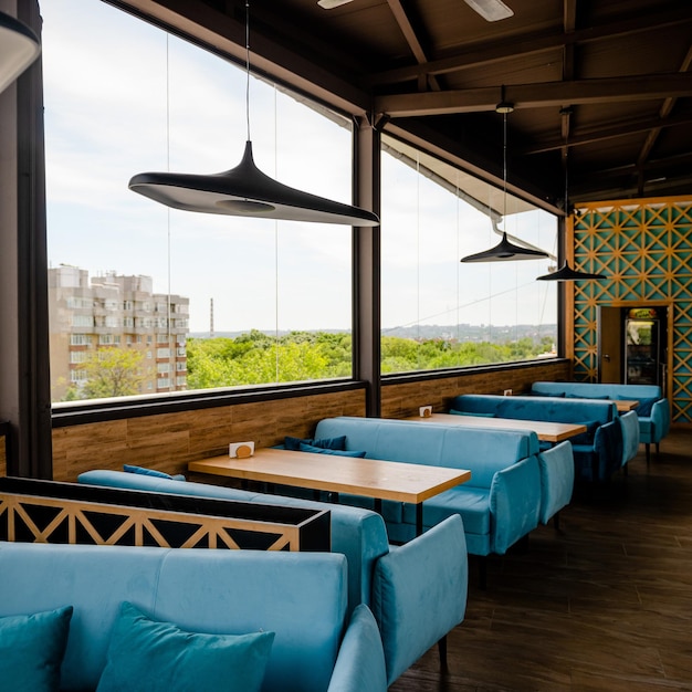 Nice inside view of a terrace at a restaurant. Rooftop cafe, modern design with a good view