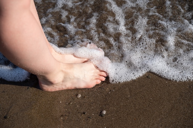 Nice legs of a pretty girl walking in water.