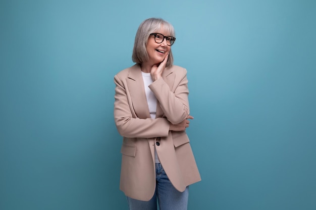 Nice neat business s lady in a stylish look on a studio background with copy space