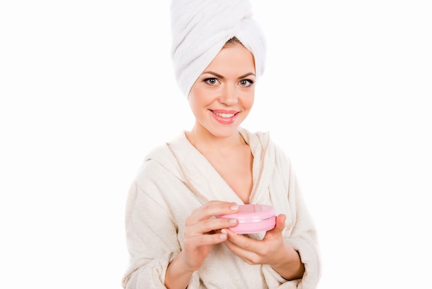 Nice pretty girl in bathroom holding cosmetic jar