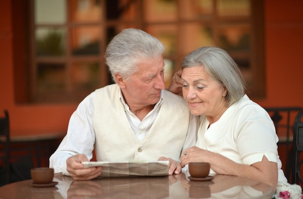 Nice senior couple with coffee on vacation