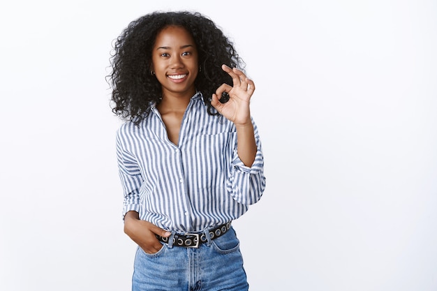 Nice work, awesome result. Satisfied pleased attractive smiling african american woman showing okay ok gesture grinning delighted excellent service recommending, affirmative positive opinion