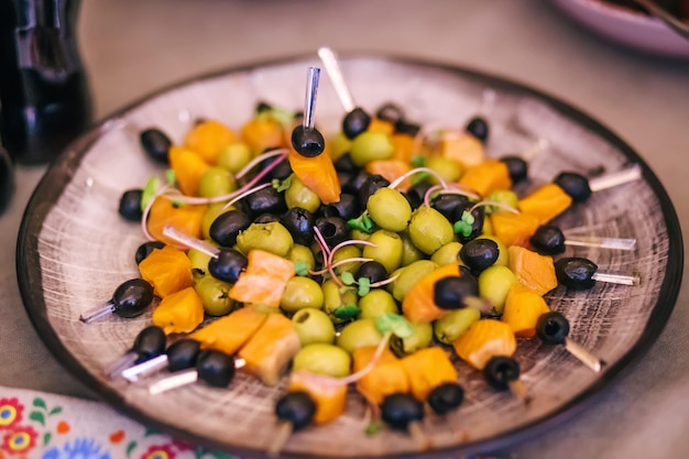 Nicely decorated banquet table with a variety of appetizers with red fish and olives