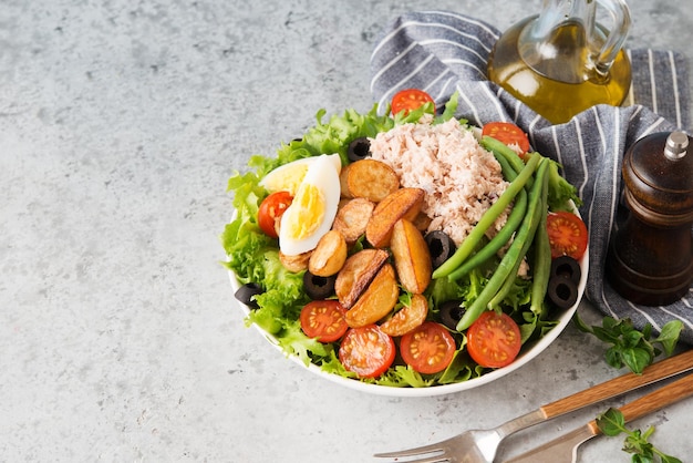 Nicoise salad with tuna, beans, vegetables and potatoes,  copy space