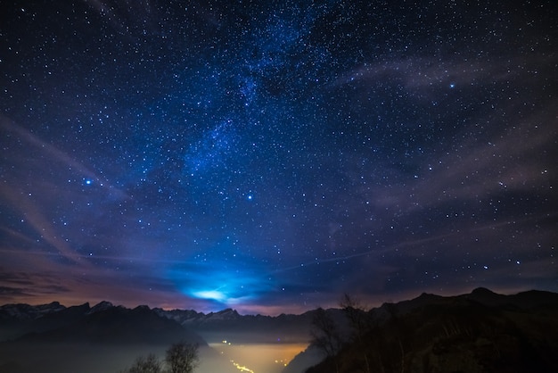 Night on the Alps under starry sky and moonlight background