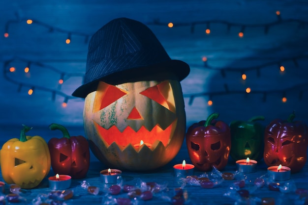 Night before Halloween. Jack lantern in hat and his friends are waiting for the holiday. Bokel effect is on the background