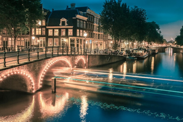 Night city view of Amsterdam canal and bridge