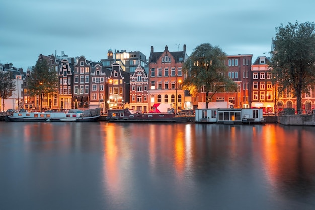 Night city view of Amsterdam canal with dutch houses