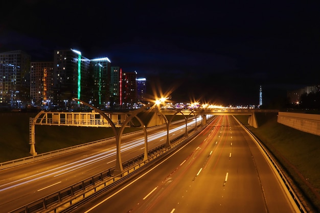 Night cityscape highway with cars light trails