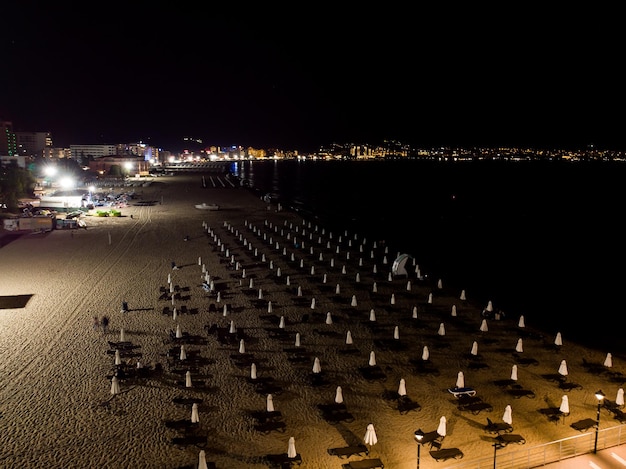 Night drone aerial view of sand beach in city center in Sunny Beach in Bulgaria Summer holidays in Europe Aerial photography drone view