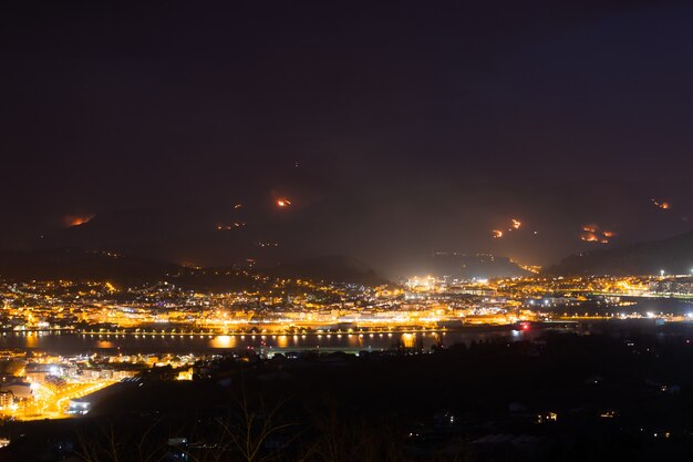 Night at Irun while a wild fire destroys the near mountains.