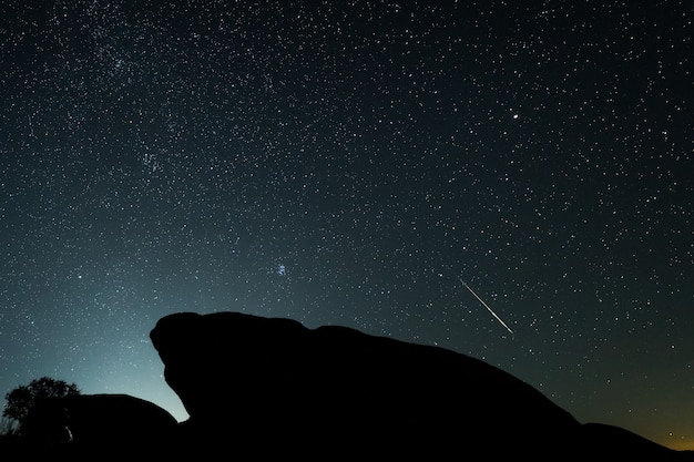 Night landscape with Perseid meteor in Barruecos.