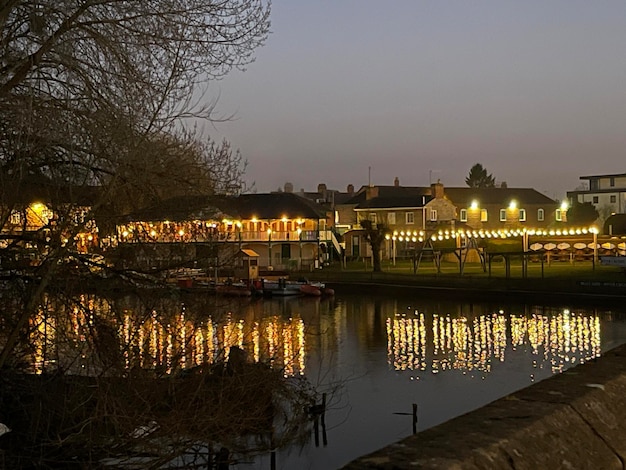 Night lights of cafes reflecting in river water in an old town