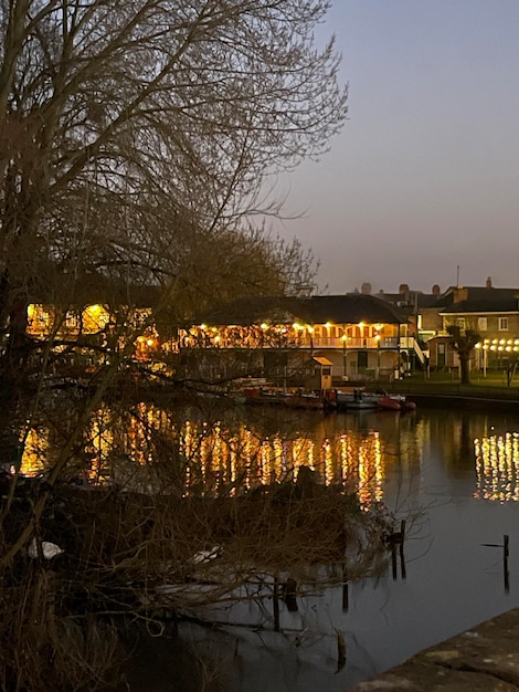 Night lights of restaurants reflecting in the river on dusk