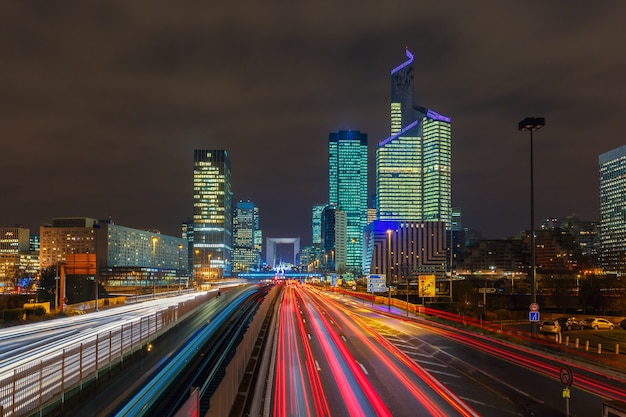 Night multi-lane road with skyscrapers of the La Defense, Paris, France. Long exposure.