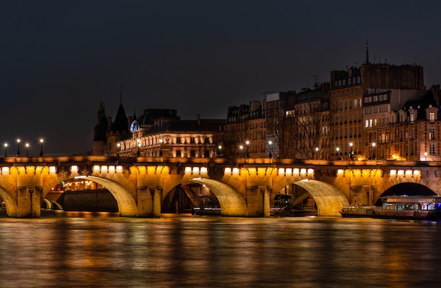 Night Paris, Pont Neuf bridge, reflection of lights in the river Seine, cityscape