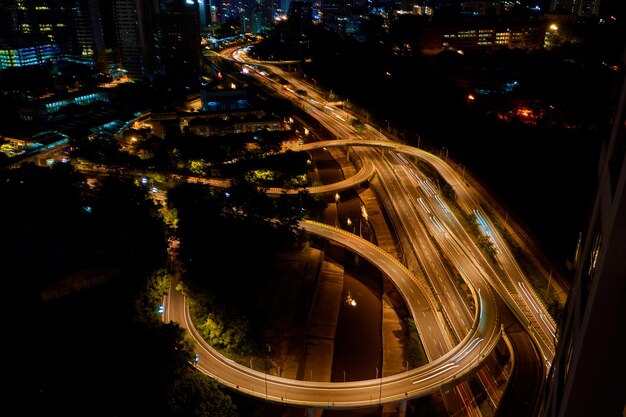 Night photo of a glowing multilevel road junction with heavy traffic Roads in the metropolis