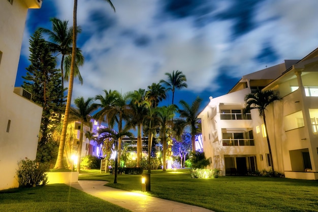 Night photo of hotel with palm trees on Mexican beaches with copyspace