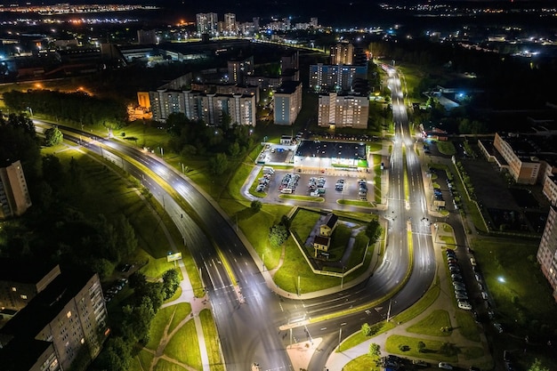 Night over road junction intersection road with cars with headlights on highway night life in big city looking down on traffic