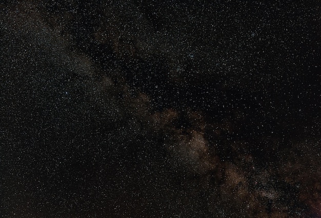 Photo night sky, many stars with milky way around aquila and scutum constellation visible. long exposure stacked photo