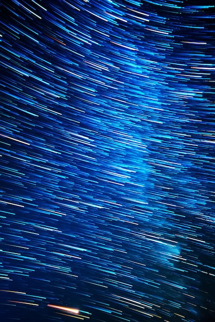 Night sky with lot of shiny star trails. Abstract natural astro background.