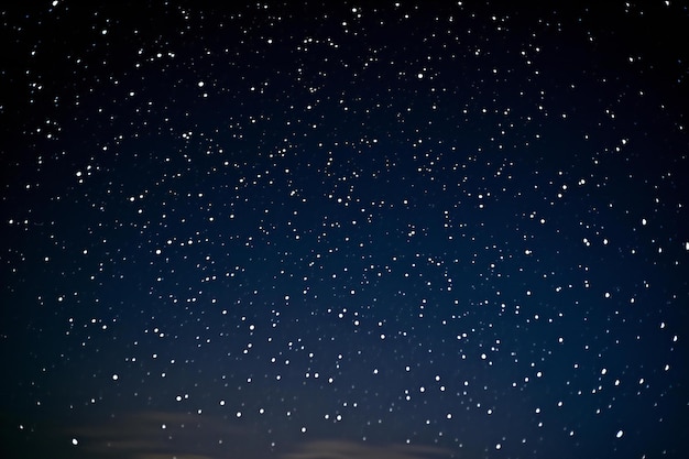 Night sky with stars and falling snowflakes Winter background