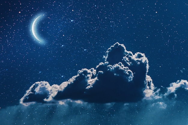 Night sky with stars and moon and clouds.