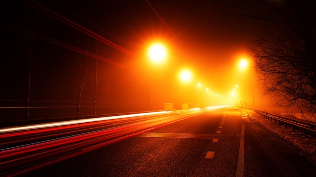 Night street on long exposure. Traces of car headlights.