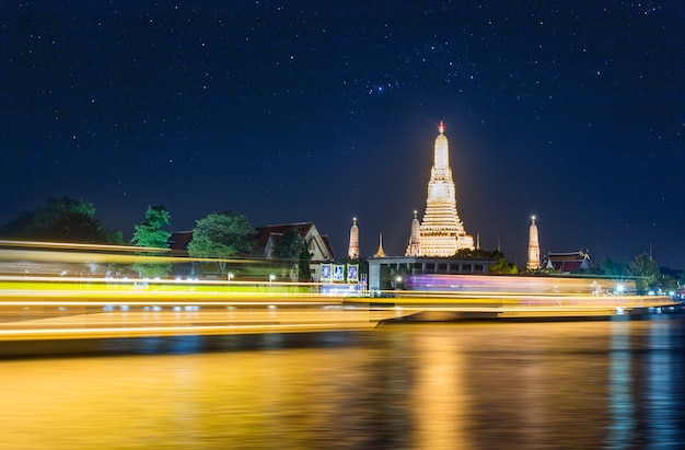 Night time view of Wat Arun (Temple) across Chao Phraya River in Bangkok, Thailand.