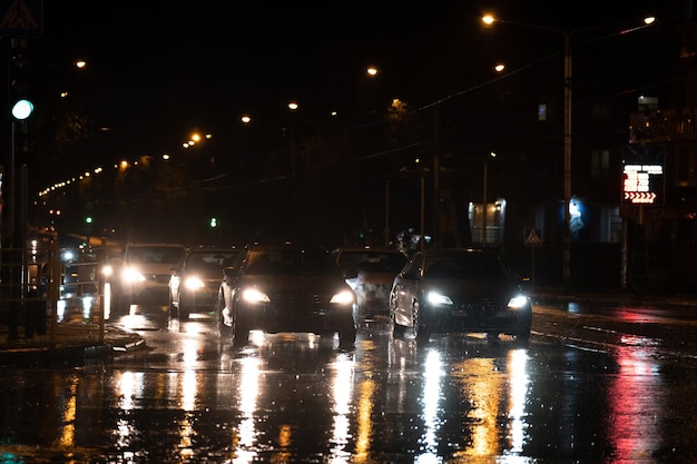 Night traffic in the city Hard rain fall at night with blurry cars Selective focus