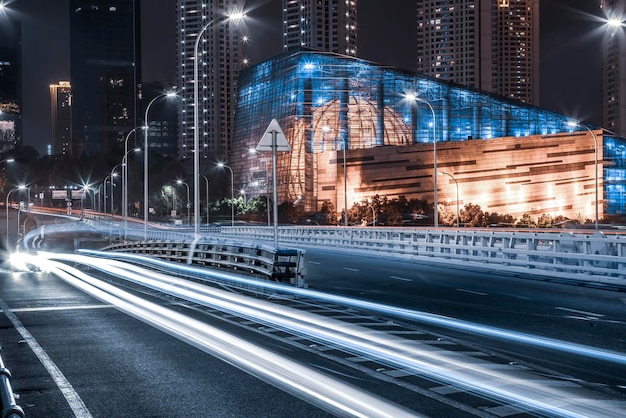 Night view of asphalt road and city buildings