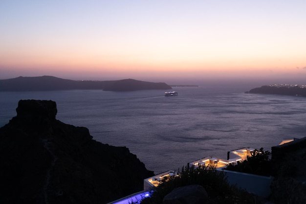 Night view of a cruise ship leaving Santorini after sunset